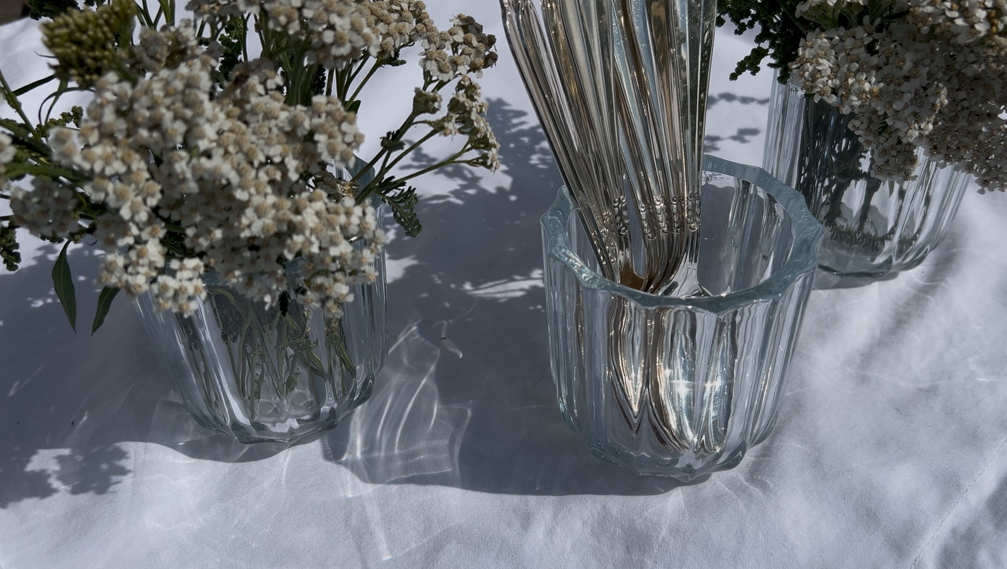 LDNL ribbed glass vases in soft summer light – styled with silverware and white yarrow for a quiet moment of table beauty.