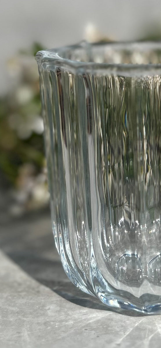 Close-up of the LDNL ribbed glass vase – soft reflections and curved clarity in natural light.